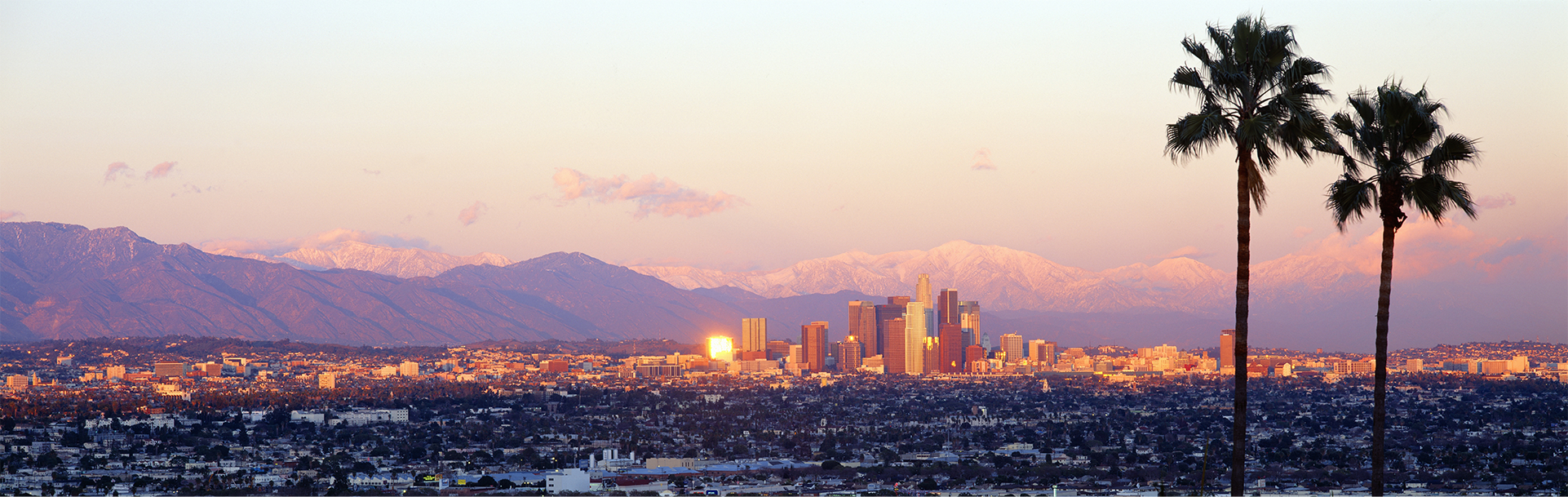 Ucan-live-in-South-California Los Angeles skyline with snow-capped mountains in the background