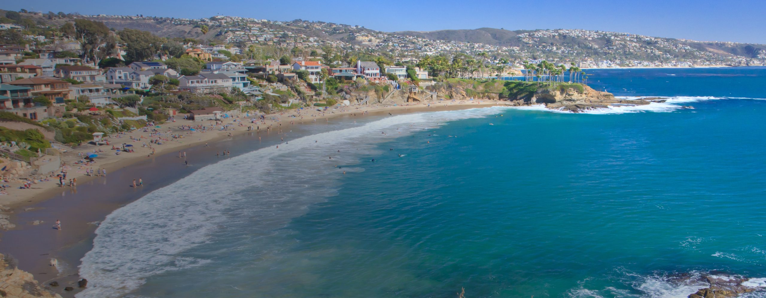 uclahea-cws-locations A stretch of the Southern California coastline with people on the beach in front of beachfront houses